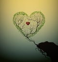 Heart shape tree growing at the edge of the rock, tree of love, Valentine symbol, grow the love concept,