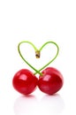 Heart shape from two cherries over white Royalty Free Stock Photo