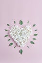 The heart shape of white hydrangea flowers on a pink background. flat lay, vertical frame, valentines cards concept Royalty Free Stock Photo
