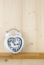 A heart shaped alarm clock on a shelf