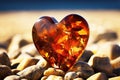 Heart shaped amber on sand on the beach at sunset Royalty Free Stock Photo