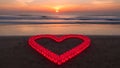 Heart-shaped arrangement of red lanterns on beach at sunset Royalty Free Stock Photo