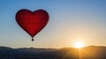 Heart-shaped balloon sunrise flight, mountains, romance Royalty Free Stock Photo