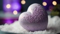 a heart shaped bath bomb sitting on top of a pile of white powdered paper on a table next to a purple candle light behind it.