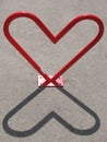 Heart-shaped bike rack and its shadow Royalty Free Stock Photo