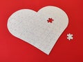 Heart shaped blank white jigsaw puzzle on red background puzzle pieces completing the heart shape Royalty Free Stock Photo