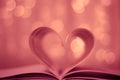 Heart shaped book on bokeh background Royalty Free Stock Photo