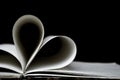 Heart shaped book pages, dark background Royalty Free Stock Photo