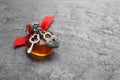 Heart shaped bottle of love potion with small key and padlock on grey table, space for text Royalty Free Stock Photo