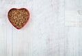 Heart shaped bowl with food for pets on wooden background. With love for animals concept and Valentine`s Day. Top view Royalty Free Stock Photo