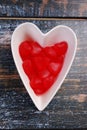 Heart shaped bowl with red candies for valentines Royalty Free Stock Photo