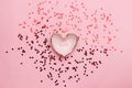 Heart shaped bowl with scattered red confetti Royalty Free Stock Photo