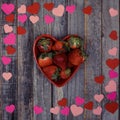 Heart shaped bowl of strawberries on wooden background Royalty Free Stock Photo