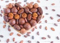 Heart shaped box with chocolates and coco beans around on a white wooden background. Flat lay. Valentine`s day, love Royalty Free Stock Photo