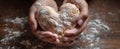 The heart-shaped bread being lovingly crafted by hands on a wooden table..AI generated image Royalty Free Stock Photo