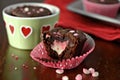 heart-shaped brownie with pink heart, red and white polka dot baking cups, and chocolate chips