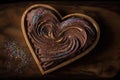 heart-shaped brownie with swirling chocolate frosting and sprinkles