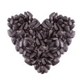 Heart shaped bunch of sunflower seeds isolated on white Royalty Free Stock Photo