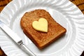 Heart shaped butter on toast Royalty Free Stock Photo