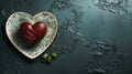 Heart-shaped cake covered with red icing on gray plate in shape of heart. On dark turquoise background. Royalty Free Stock Photo