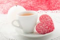 Heart-shaped cake with a cup of green tea