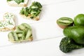 Heart shaped canape with creamy cheese, broccoli, microgreen, parsley and kiwi near green fruits and vegetables Royalty Free Stock Photo