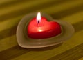 Heart-shaped candle with flame Royalty Free Stock Photo