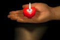 Heart shaped candle in hand Royalty Free Stock Photo