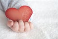 Heart shaped card in baby hand
