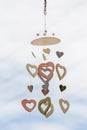 Heart shaped ceramic wind mobile hanging with defocused blue sky Royalty Free Stock Photo