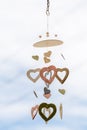 Heart shaped ceramic wind mobile hanging with defocused blue sky Royalty Free Stock Photo