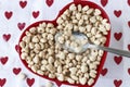 Heart shaped cereal in a red heart shaped bow Royalty Free Stock Photo