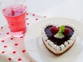 Heart shaped cheesecake with graham cracker crust, cream cheese filling and raspberry jelly for Valentine`s Day