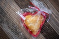 Heart-shaped cherry hand-pie wrapped in cellophane Royalty Free Stock Photo