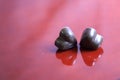 Heart shaped chocolade on a red background.