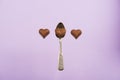 Heart shaped chocolate candies and spoon isolated on pink Royalty Free Stock Photo
