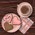 Heart shaped chocolate coral cookies in plate, coffee in cup and checkered napkin on wooden table