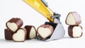 Heart-shaped chocolates in the bucket of a toy excavator. Concept of choosing a love partner, creating a family, dating service