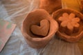 Heart shaped clay object in view