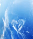 Heart shaped cloud on blue sunny sky. Royalty Free Stock Photo