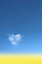 Heart shaped cloud on bright blue sky. Royalty Free Stock Photo