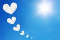heart shaped clouds on blue sky and sun shines Royalty Free Stock Photo