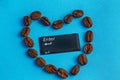 Heart shaped coffee beans on a blue background in the center enter button