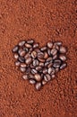 HEART SHAPED COFFEE BEANS ON INSTANT COFFEE BACKGROUND Royalty Free Stock Photo