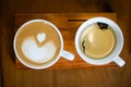 Heart-shaped coffee on a brown wood table