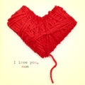 Heart-shaped coil of red yarn and text I love you, mom Royalty Free Stock Photo