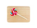 Heart shaped colorful lollipop on wooden tray, white background Royalty Free Stock Photo