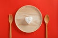 Heart shaped cooked rice in wooden plate on red background.