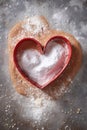 heart-shaped cookie cutter on a flour-dusted surface Royalty Free Stock Photo