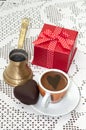 Heart shaped cookie with red gift box with bow and cup of coffee Royalty Free Stock Photo